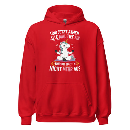 Weißer Hoodie mit buntem Einhorn beim Meditieren und dem lustigen Spruch „Und jetzt atmen alle mal tief ein und die Idioten nicht mehr aus“ in schwarzer und pinker Schrift.
